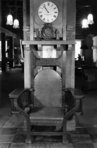 Circa 1940s - Seen on display at the Mission Inn in Riverside is the oversized chair built specifically for President Taft's 1909 visit to the Inn (Calisphere)